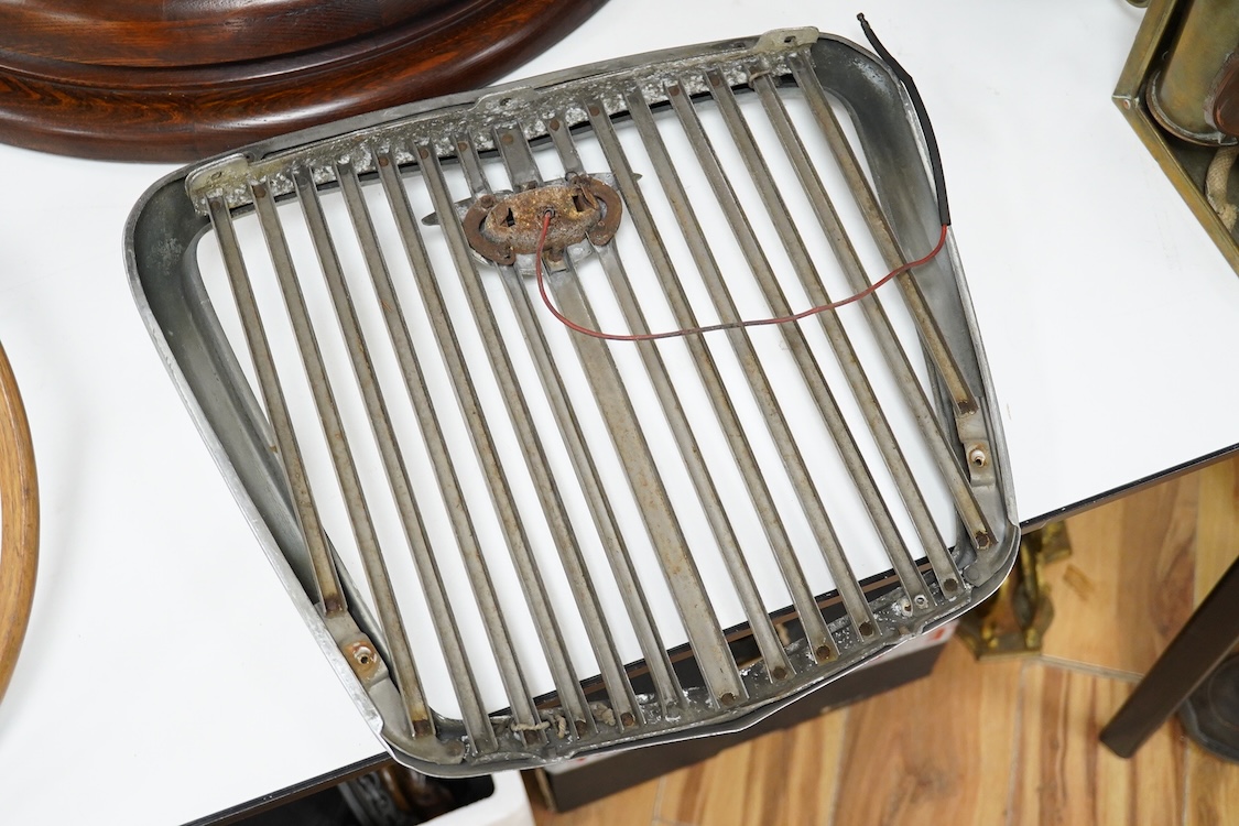 A 1950s Wolseley automobile radiator grill, with a lit logo to the centre of the grill, 40cm x 43cm